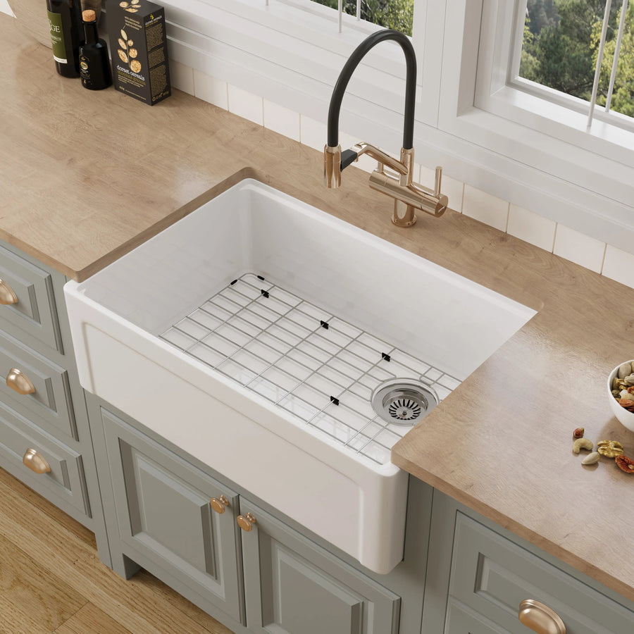 Modern farmhouse kitchen featuring a white fireclay workstation sink with rear offset drain