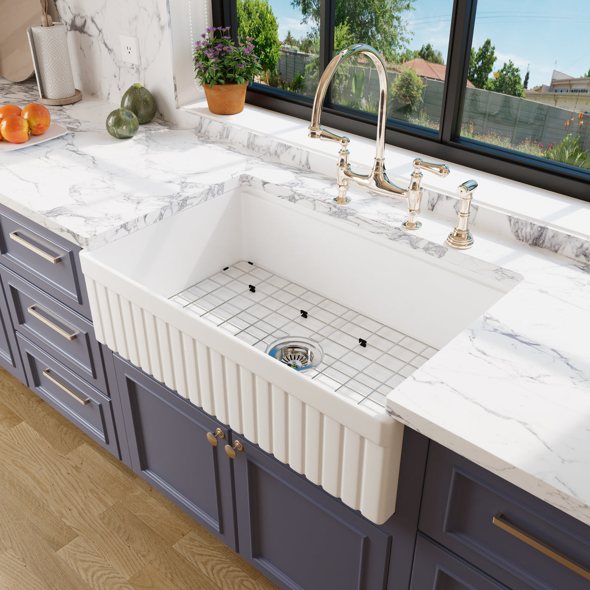 Bowl of the 33 inch fluted fireclay farmhouse sink with stainless steel bottom grid and basket strainer drain