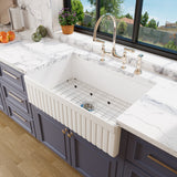 Bowl of the 33 inch fluted fireclay farmhouse sink with stainless steel bottom grid and basket strainer drain