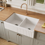 33 inch fireclay double bowl farmhouse sink with the fluted apron side facing out, showing equal 50/50 bowls and two drains