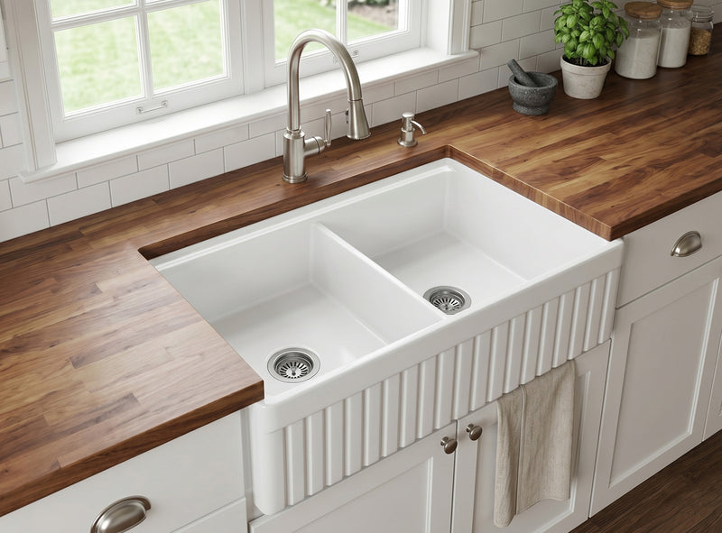 33" fireclay double bowl farmhouse sink installed in kitchen with wooden countertop and classic apron front design