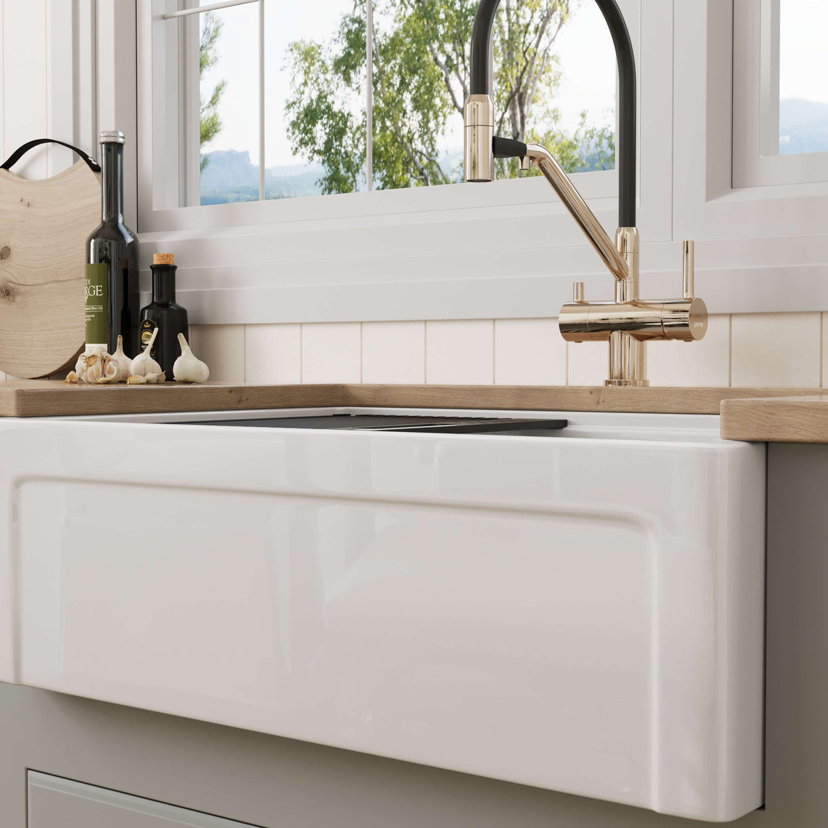 30 inch Grooved Apron Fireclay Farmhouse Sink with Workstation Kit installed under a kitchen window with wood countertop accents and brass pull-down faucet