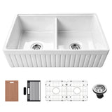 33 inch white fireclay double bowl farmhouse sink with fluted apron front, cutting board, utensil holder, roll-up drying rack, two bottom grids, and drain assembly.