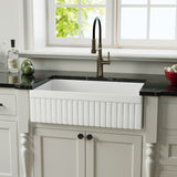 33 inch reversible apron fireclay farmhouse sink with fluted front and black countertop
