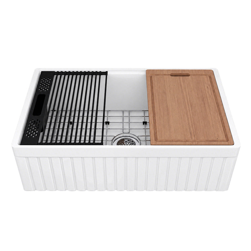 NOZLOO 30-inch fluted apron fireclay farmhouse workstation sink with sapele cutting board, roll-up drying rack, black colander, and stainless steel bottom grid on a white background