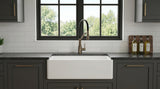 White 33" Smooth Apron Fireclay Farmhouse Sink with dark green cabinets and marble countertop