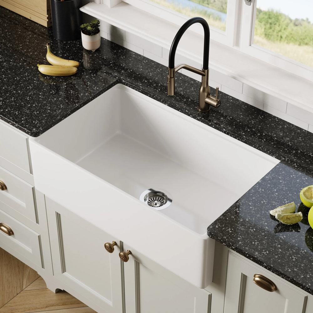 White 33" Smooth Apron Fireclay Farmhouse Sink with black granite countertop and brass faucet
